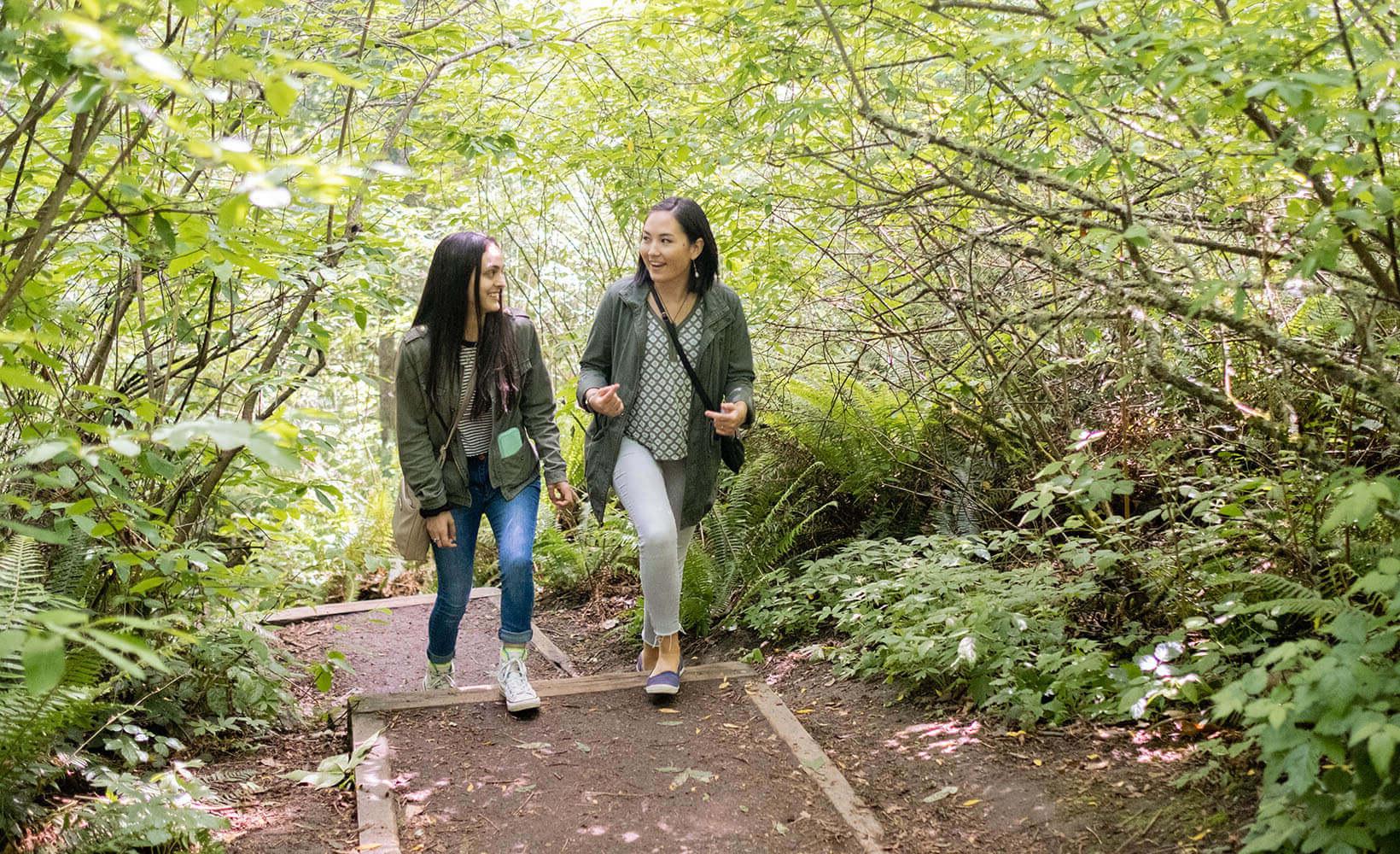 Two SPU students walking through the forest | photo by Chris Yang